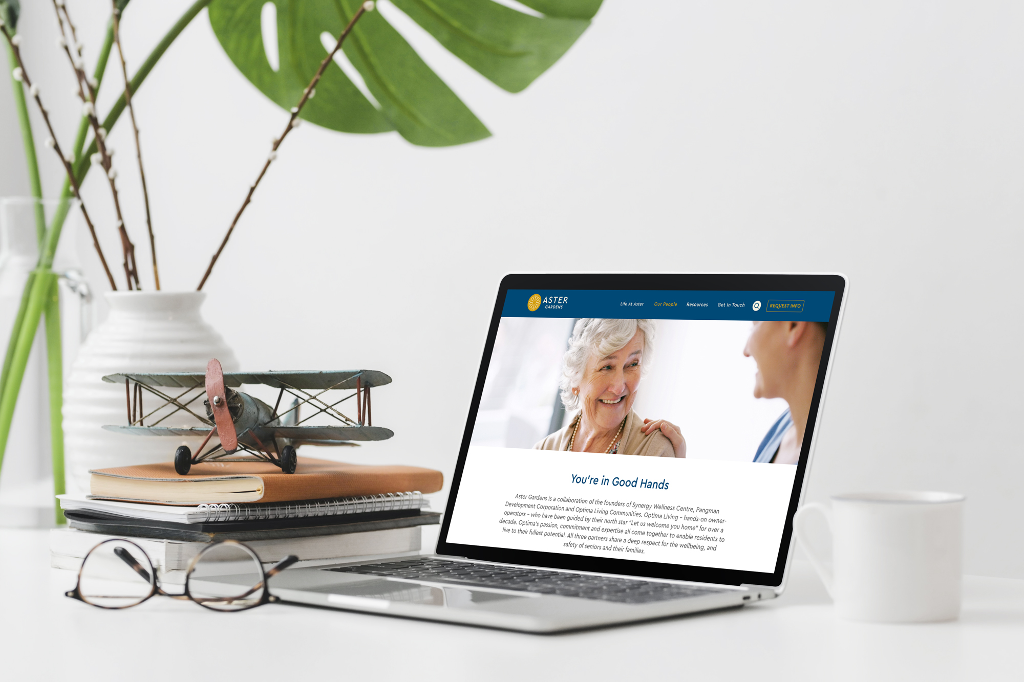 Aster Gardens homepage on a laptop