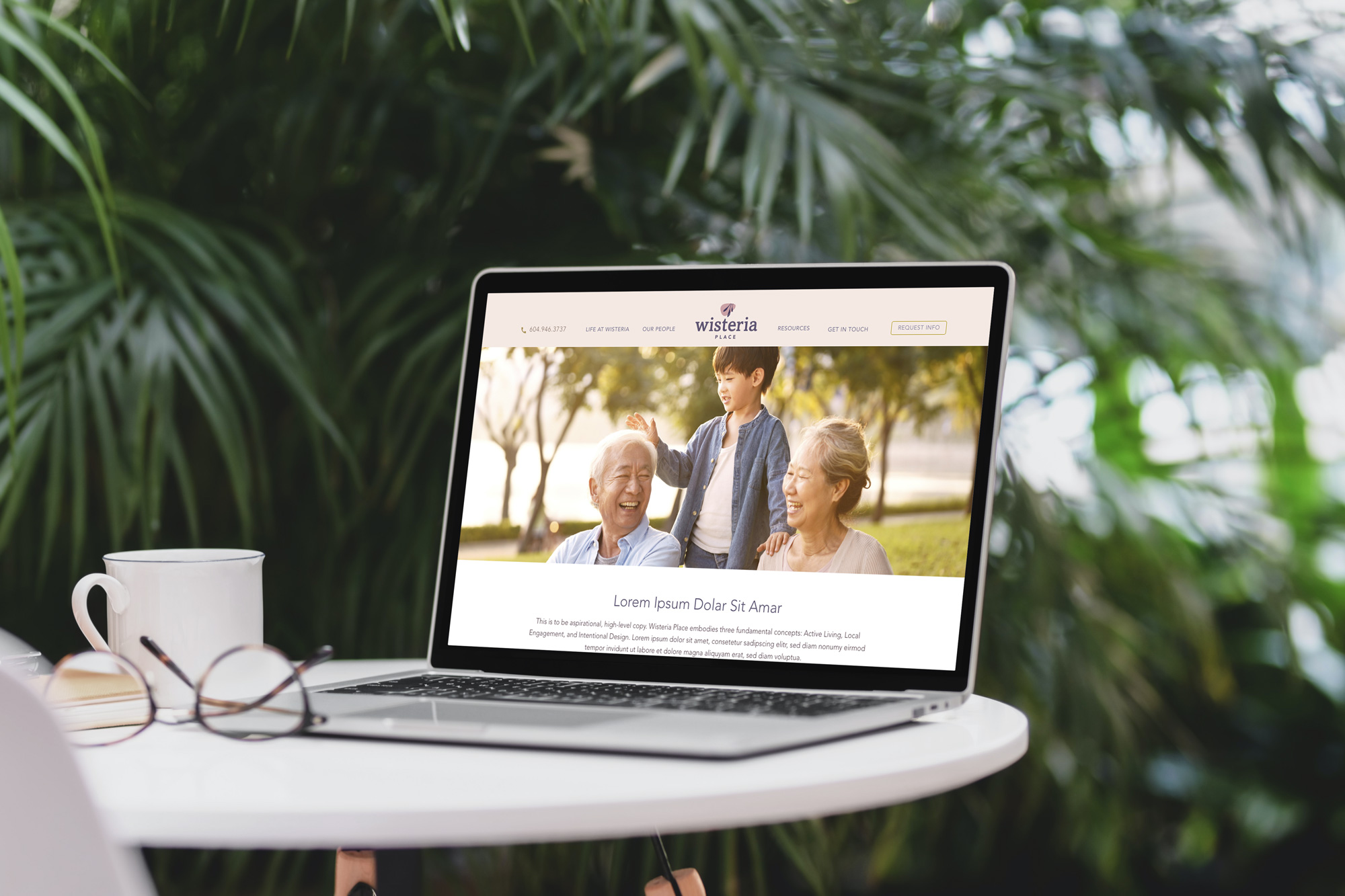 Laptop on the desk with Wisteria Place homepage open