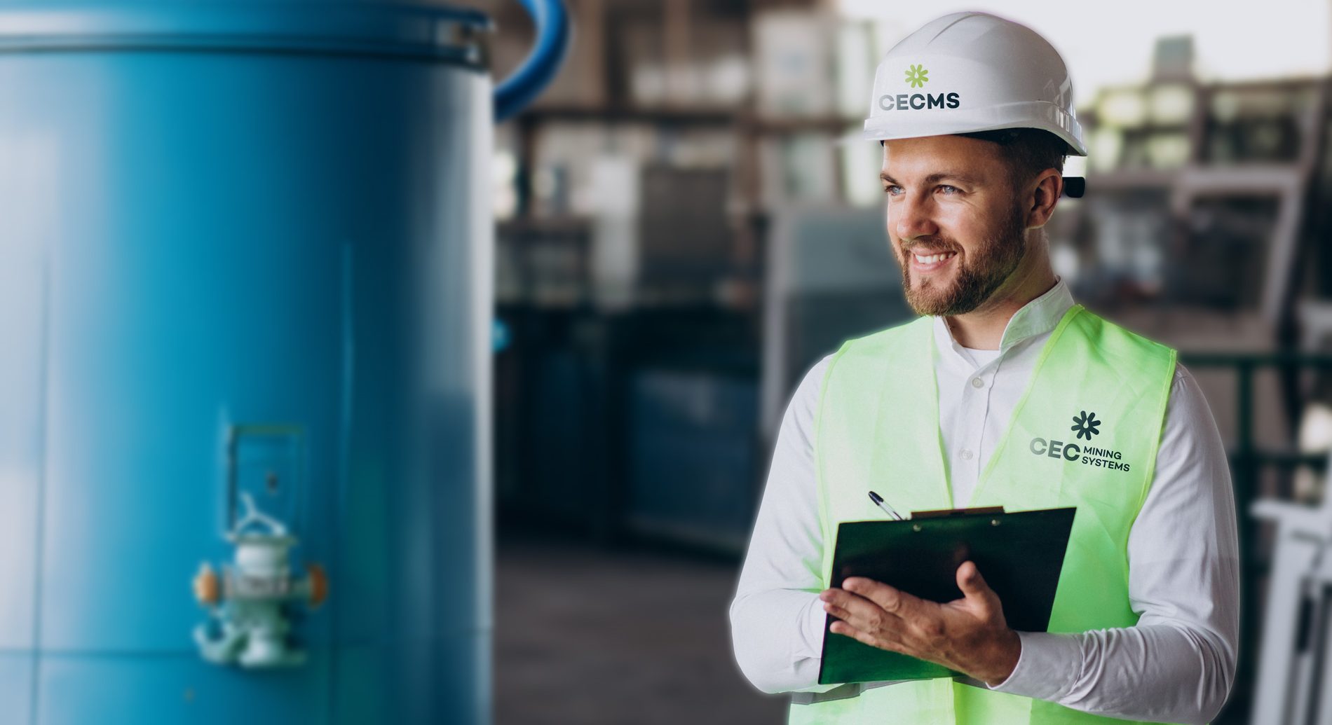 Young man engineer with a hard hat working at a factory